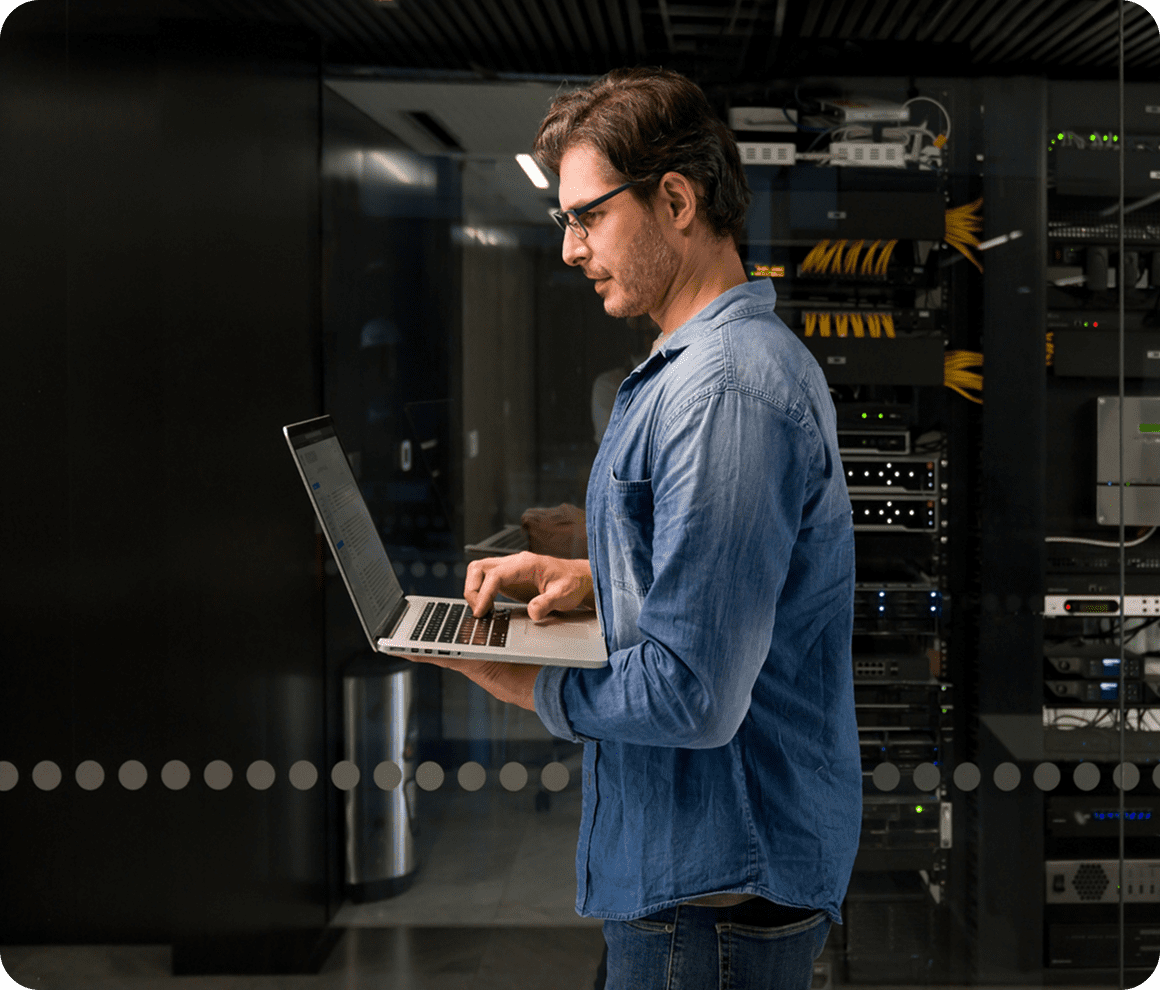 Technician managing servers with a laptop